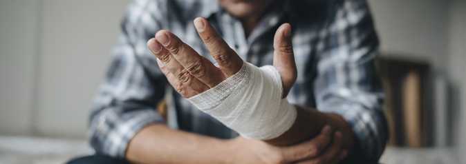 Man with a gauze bandage wrapped around his hand