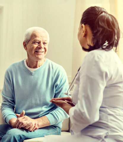 cheerful elderly gentleman consulting with nurse