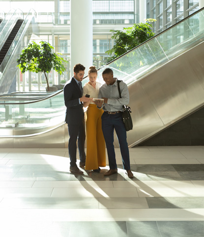 diverse young business people with tablet talking in the atrium