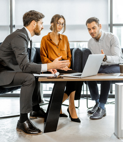 young couple with financial advisor at the office