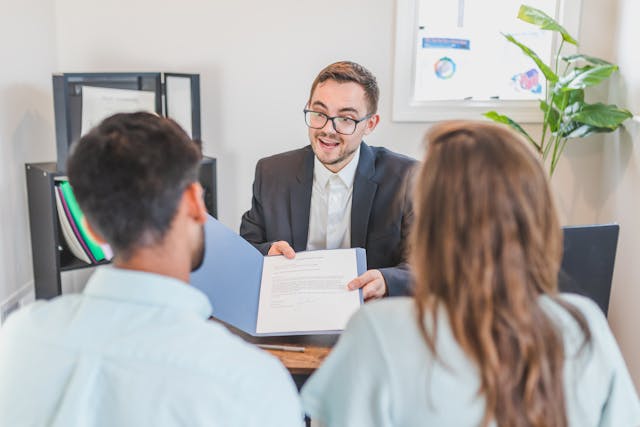 man showing two people paperwork